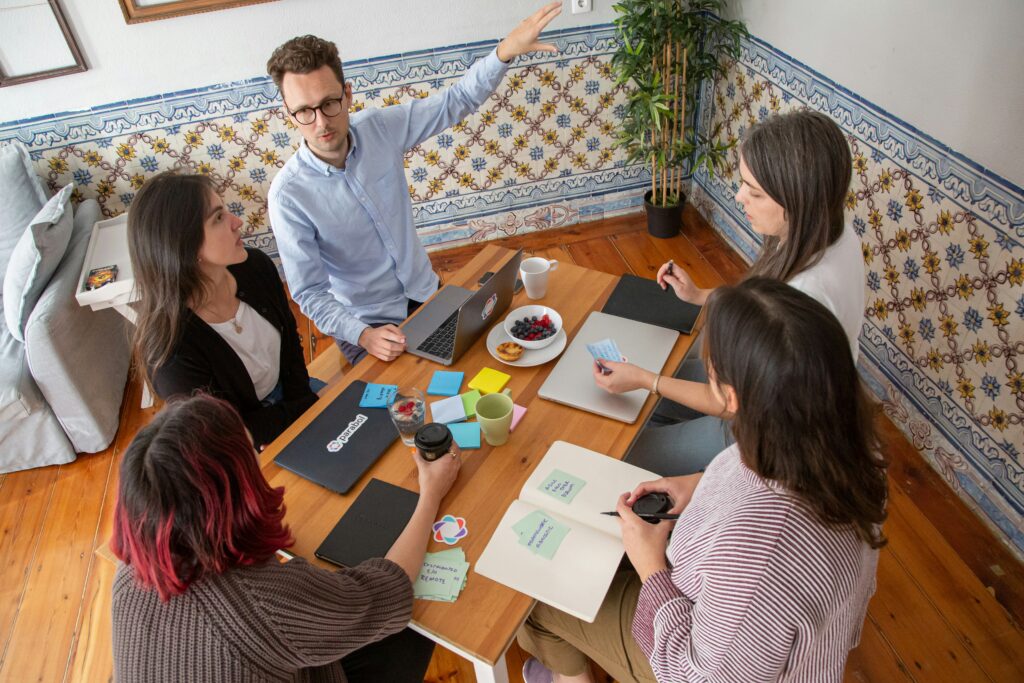 Sales team sitting around a table discussing plans and strategies