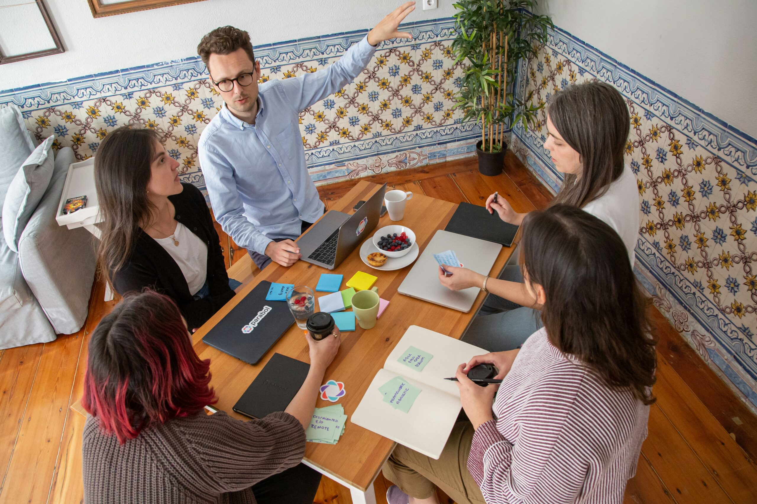 Sales team sitting around a table discussing plans and strategies