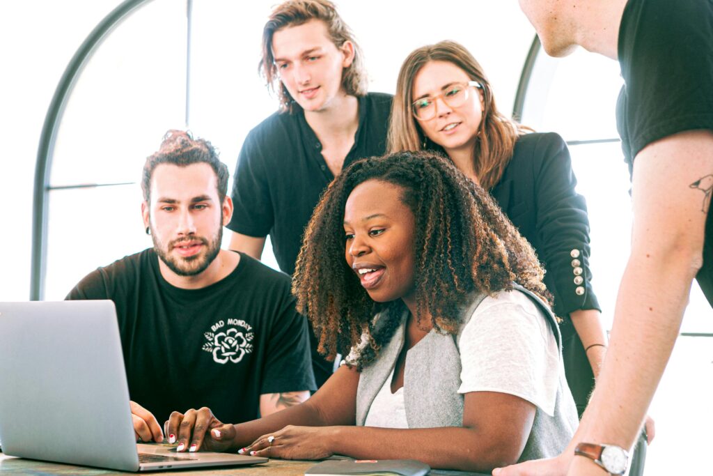 Team members working on a website on a laptop