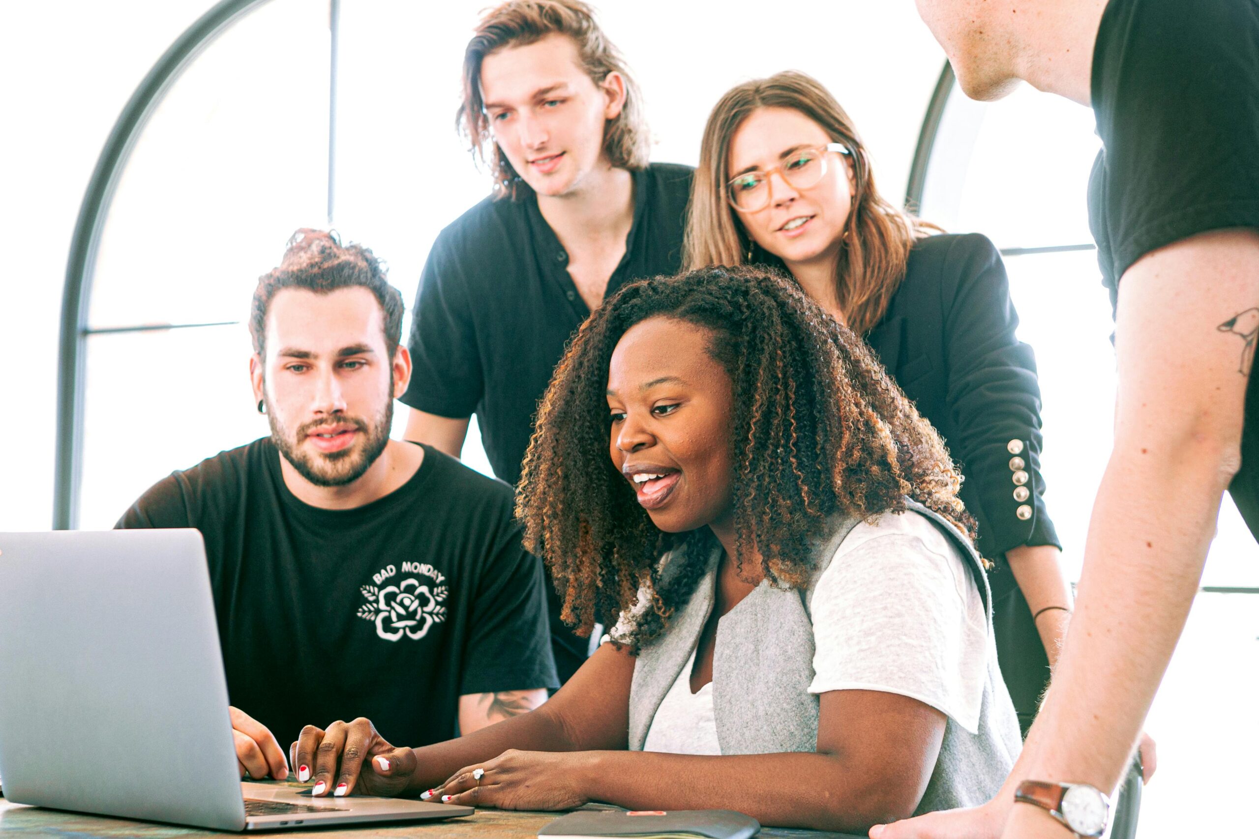 Team members working on a website on a laptop