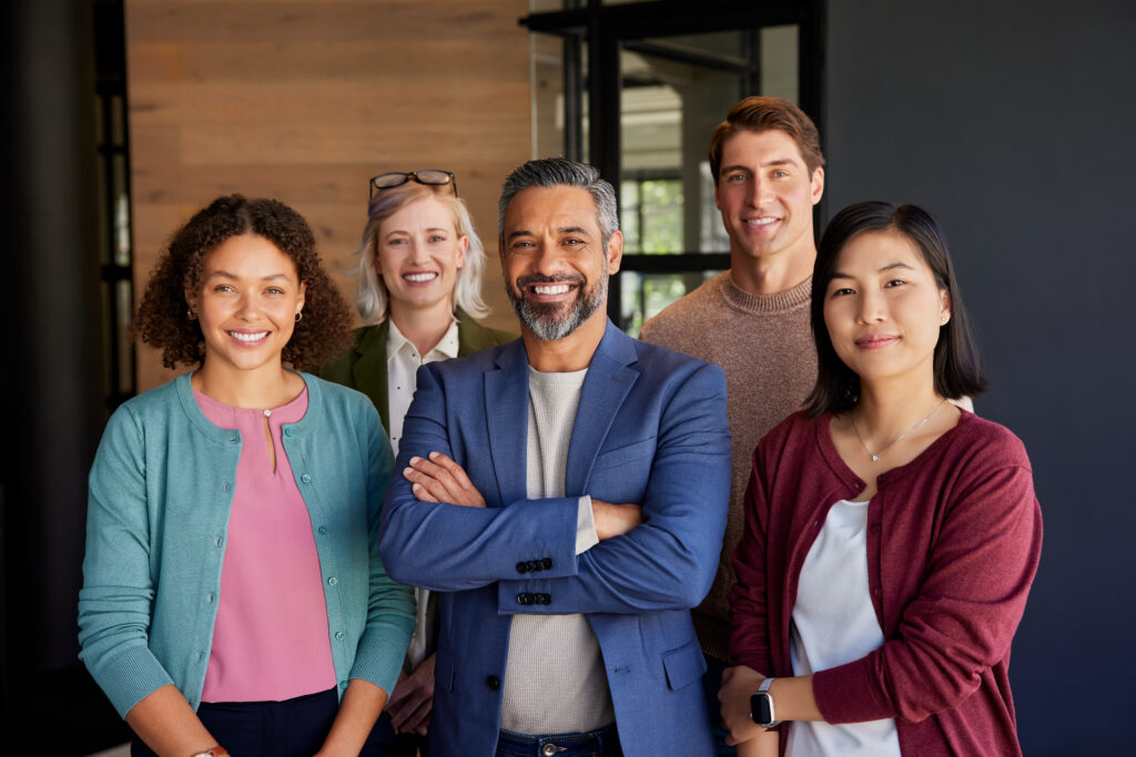 Team of direct marketers smiling in their office
