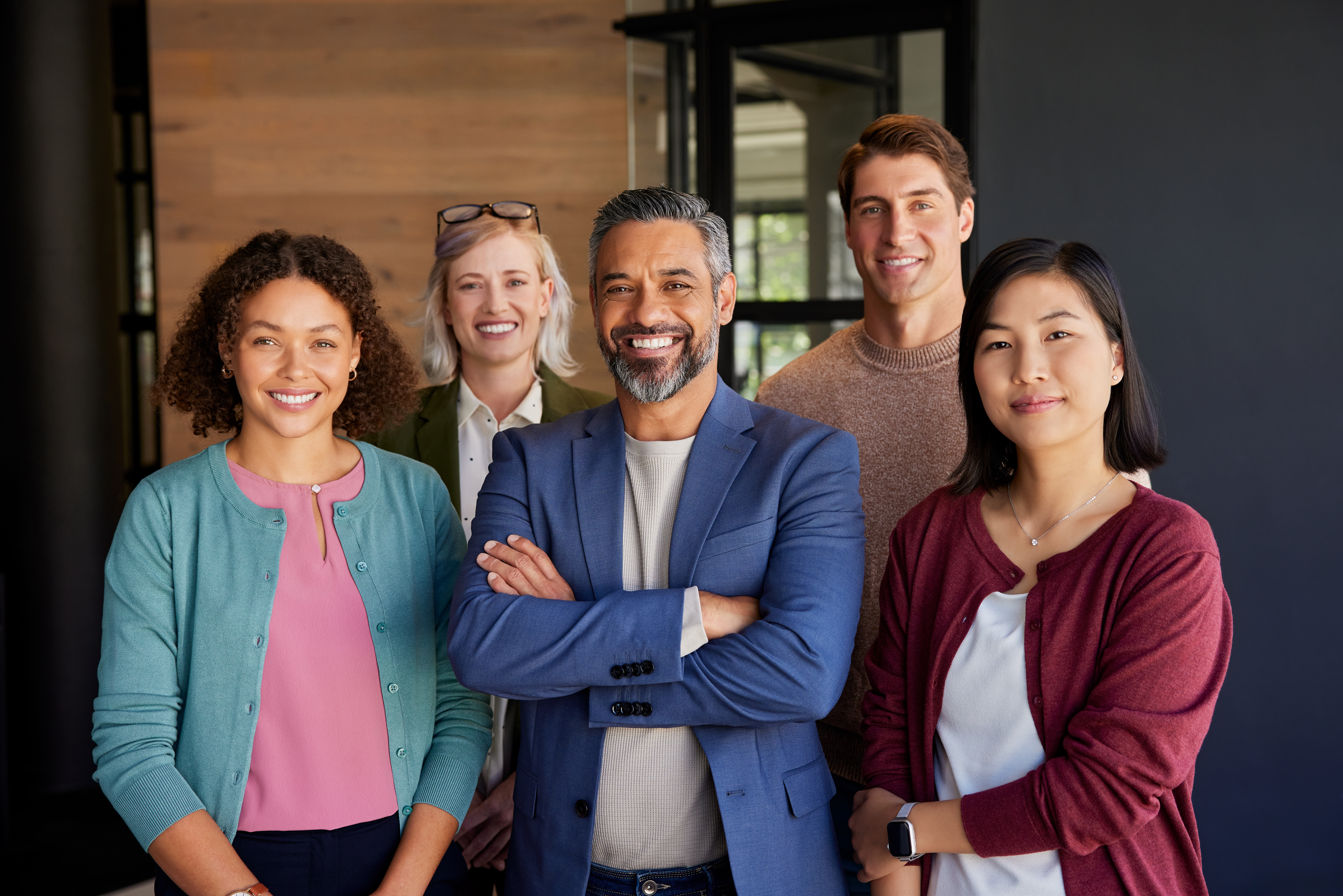 Team of direct marketers smiling in their office